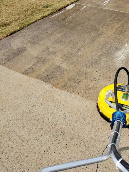 Showing before-and-after results of driveway cleaning in Marysville WA using a surface cleaner